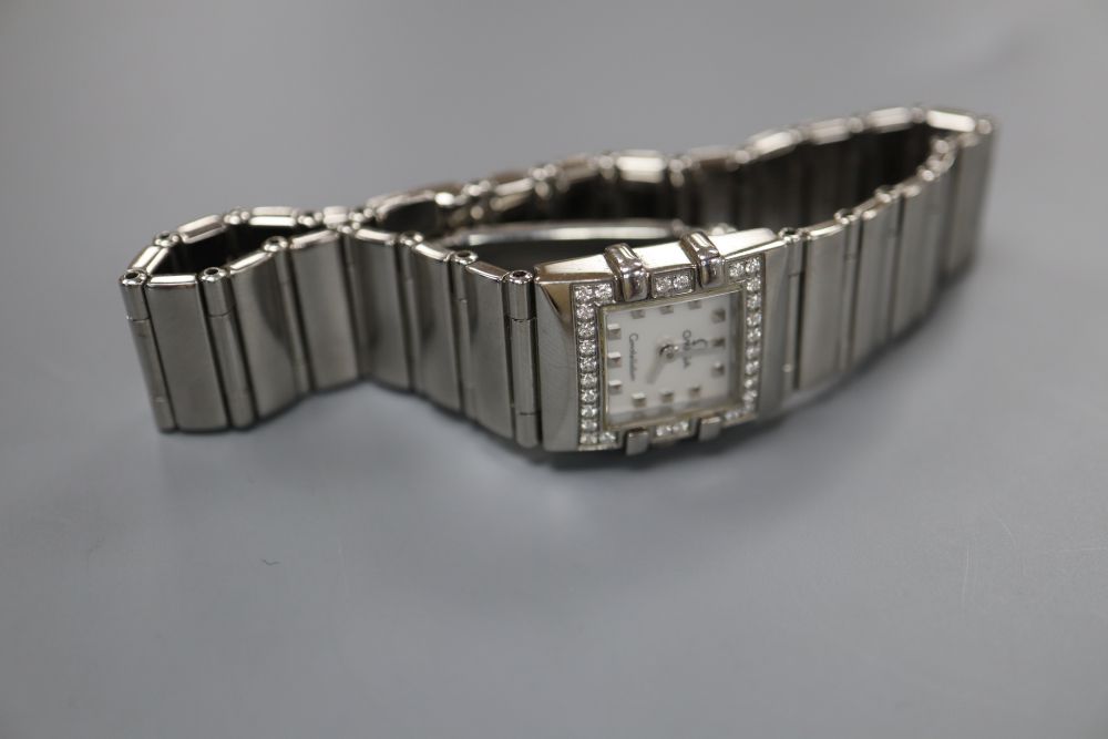 A ladys stainless steel Omega Constellation quartz? wrist watch, with square mother of pearl dial and diamond set bezel,